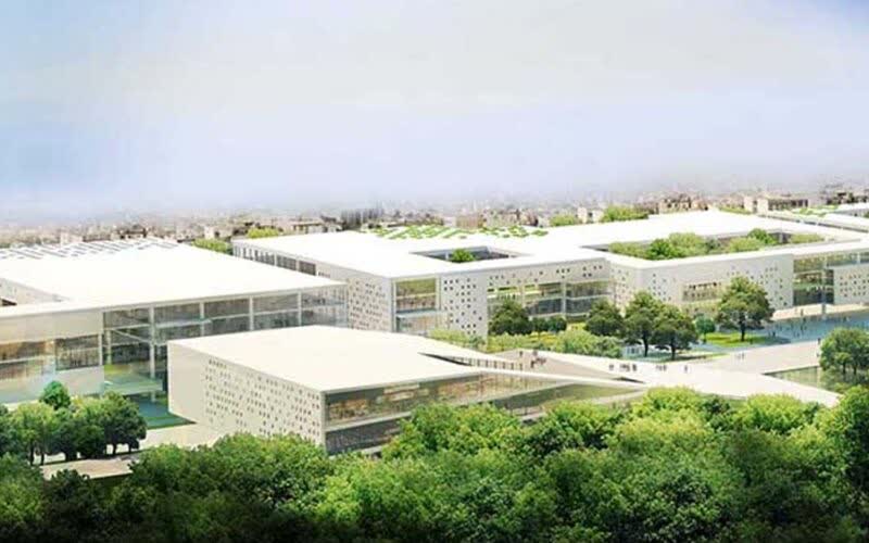 Aerial render of a low white civic complex with flat roofs and courtyards, set among dense green trees